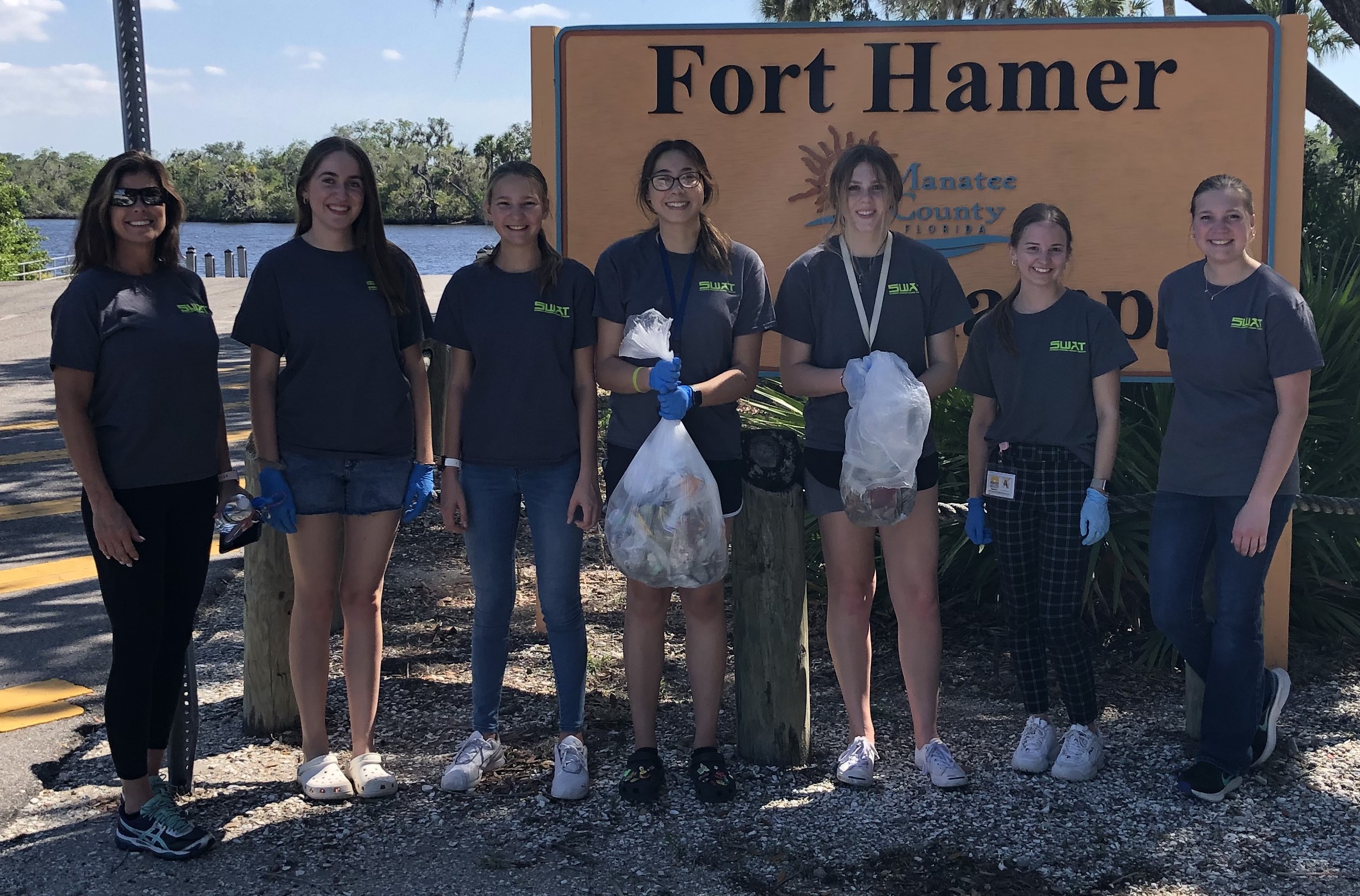 Manatee SWAT members display the butts, filters, boxes, lighters, and other tobacco-related litter collected during a clean-up event at Fort Hammer in Parrish.