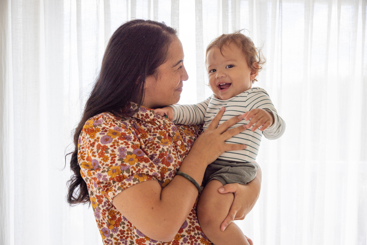 Happy mother holding toddler